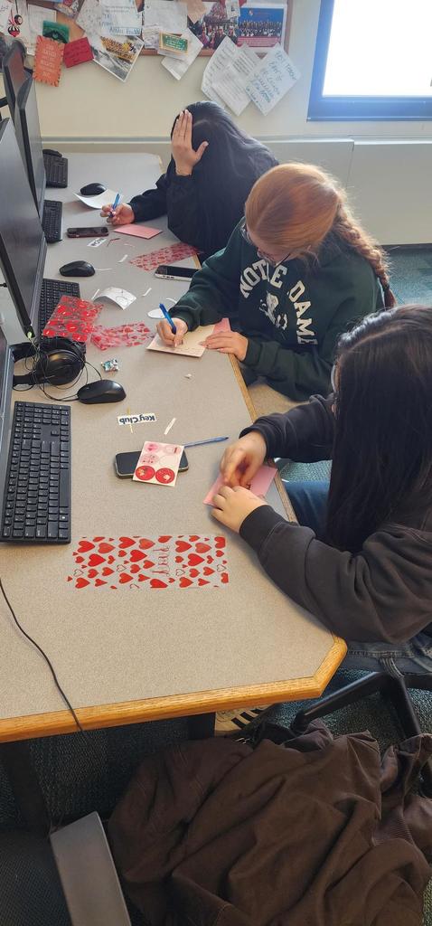 3 female students write cards