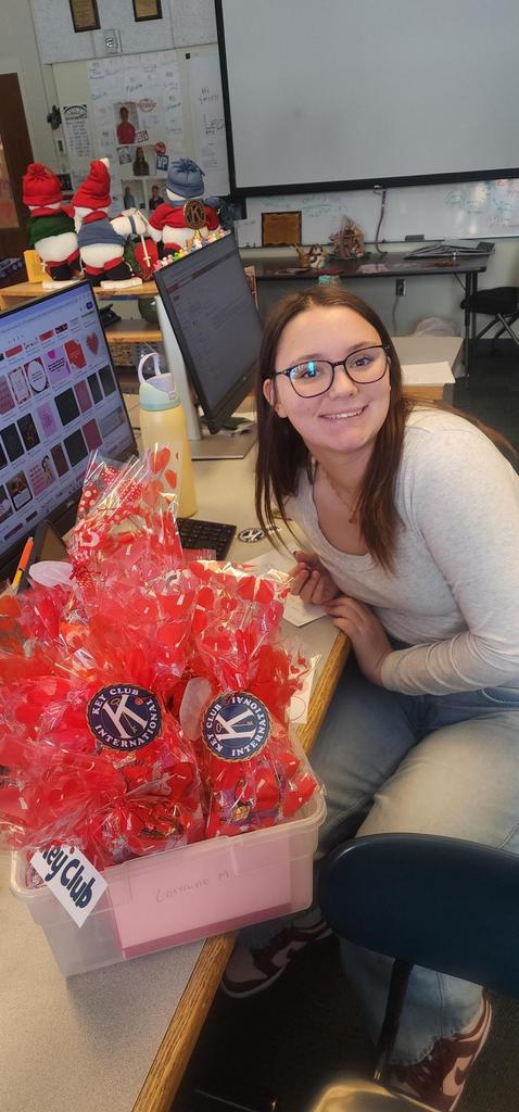Female student smiling with Valentine goodie bags