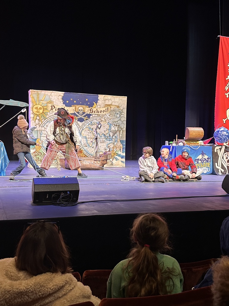 students on stage with performers