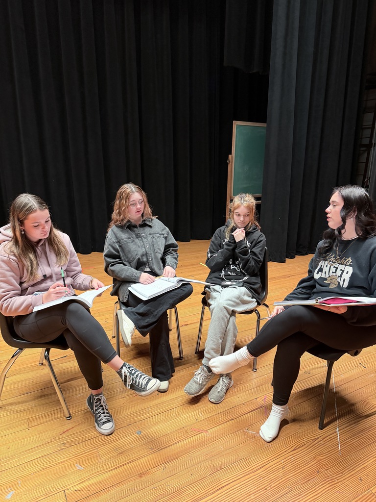 a group of students learn their lines. 