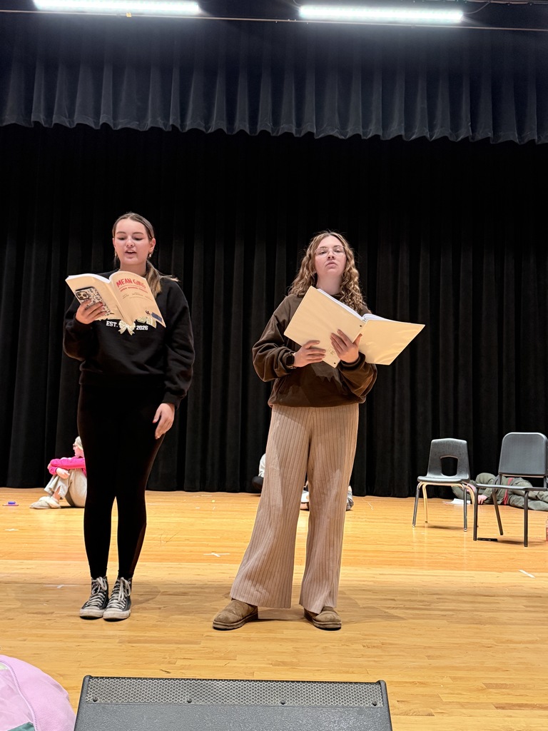 two students read their lines.