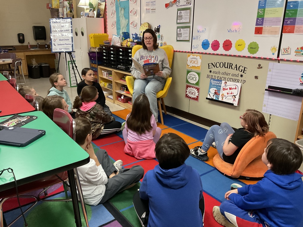 Students look on as Mrs. Krystofiak reads a book