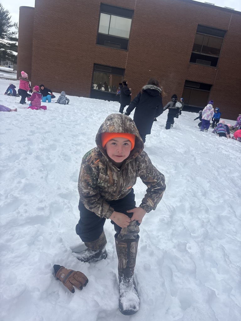 a student kneels in the snow. 