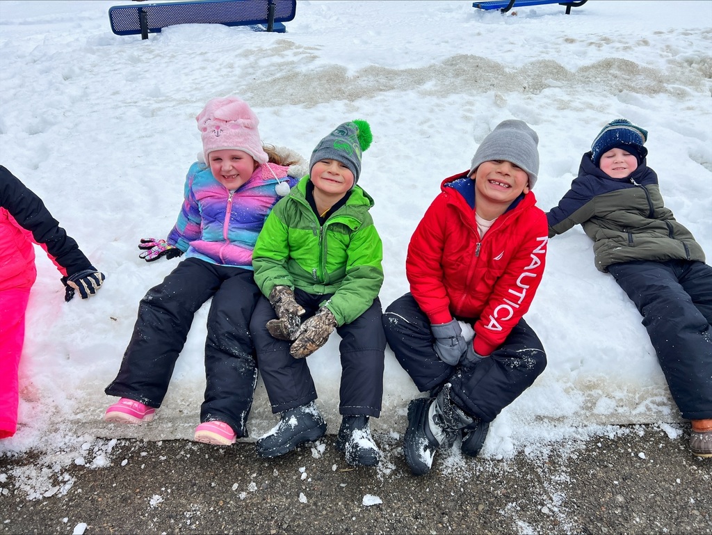 students sit in the snow.