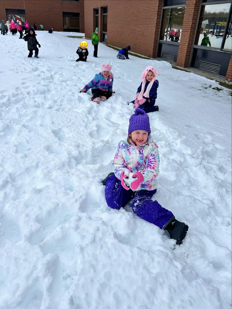 students sit in the snow.
