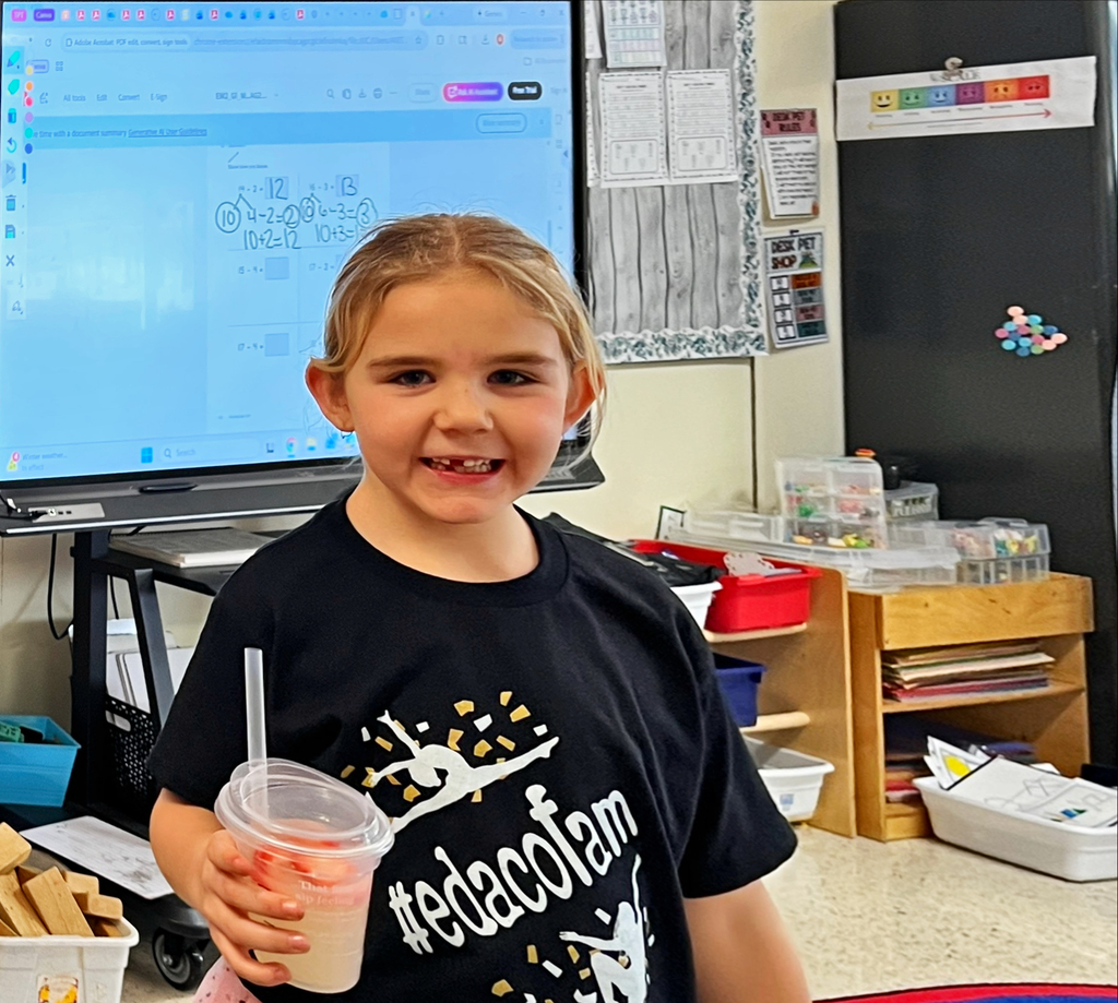 a student holds a drink