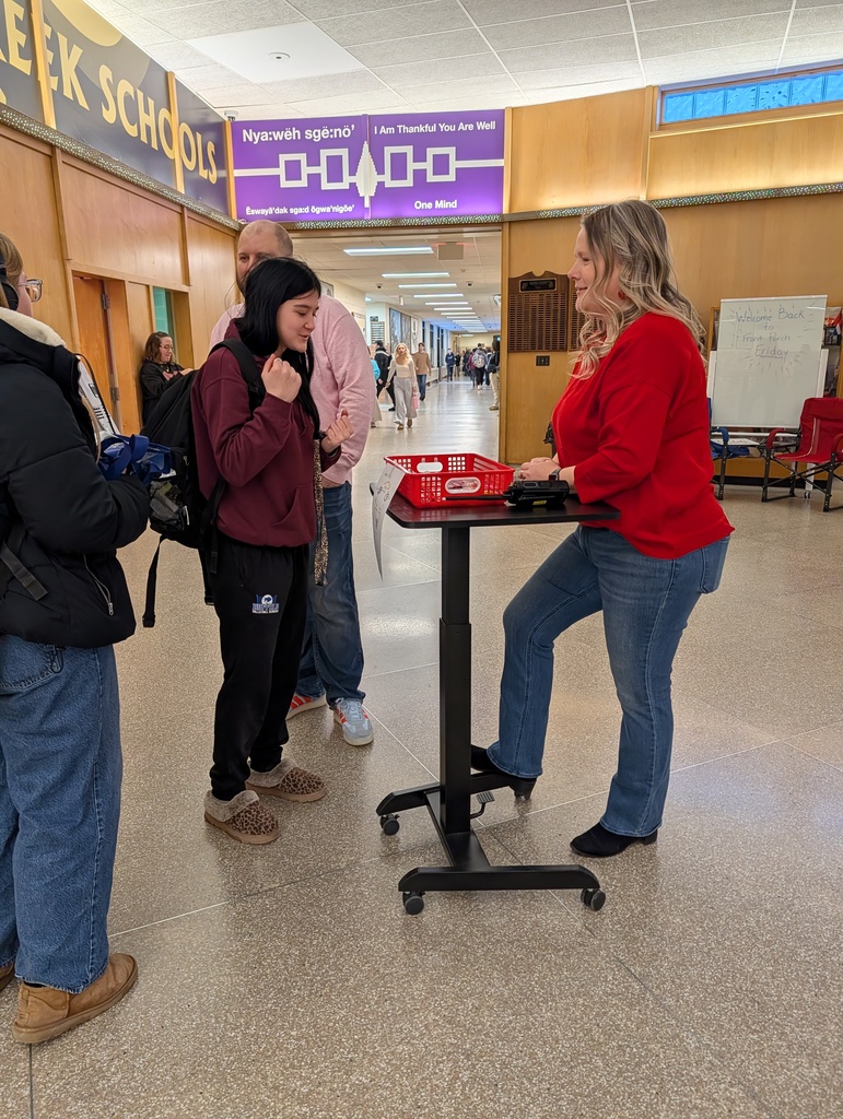 A girl looks at the prizes with Mrs. Cook