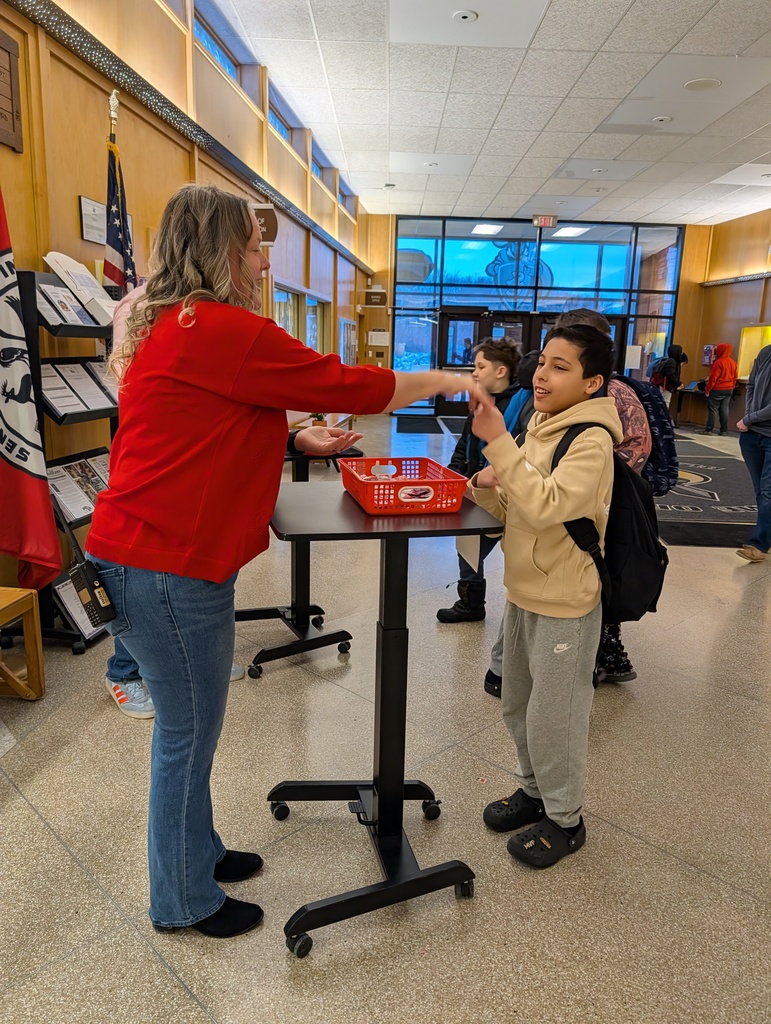 Mrs. Cook plays rock,paper, scissors with a boy