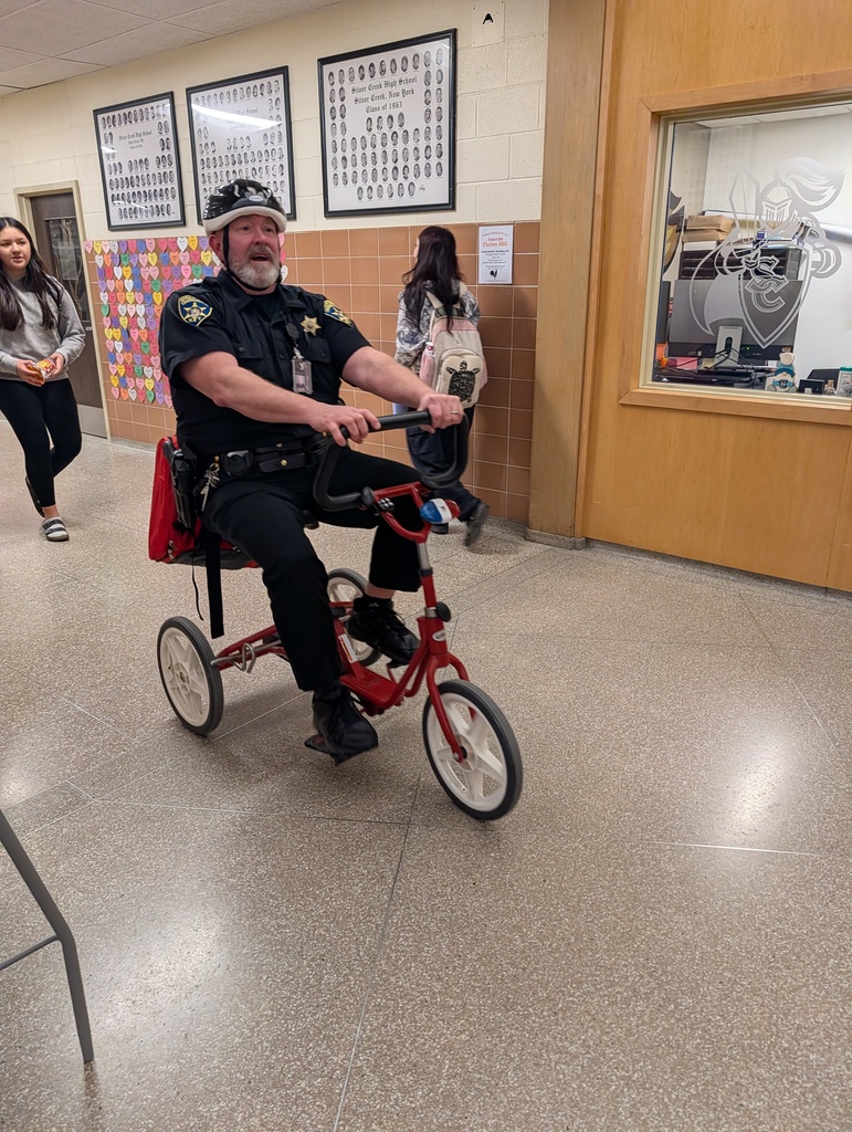 Officer Johnson rides his bike through the halls