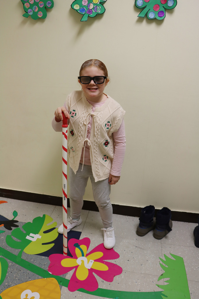 A girl dresses as a 100 year old with a cane