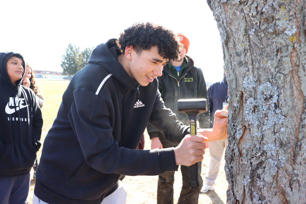student hammers in the spout.