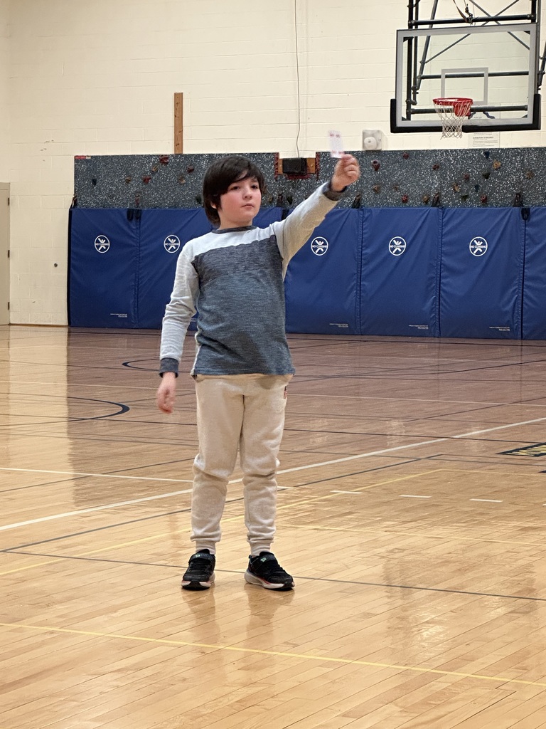 Boy showing a card in the gym