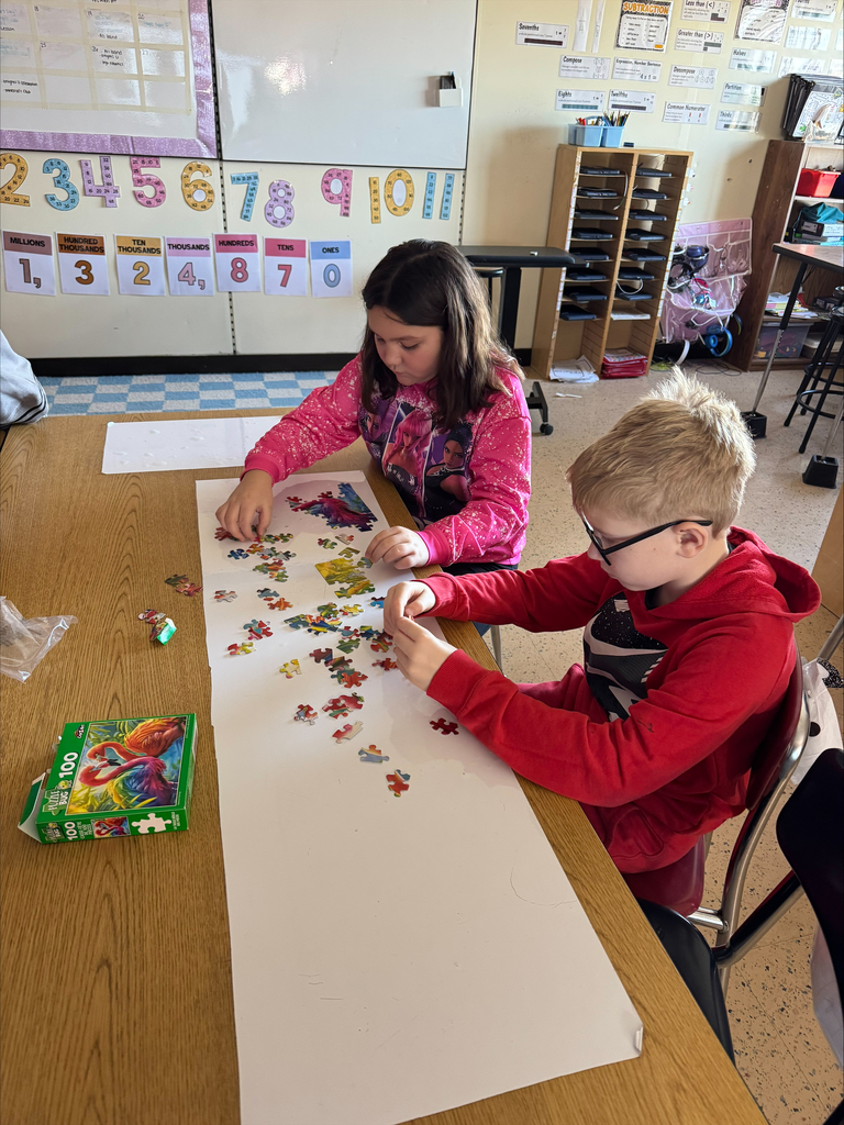 A girl and a boy working on a puzzle