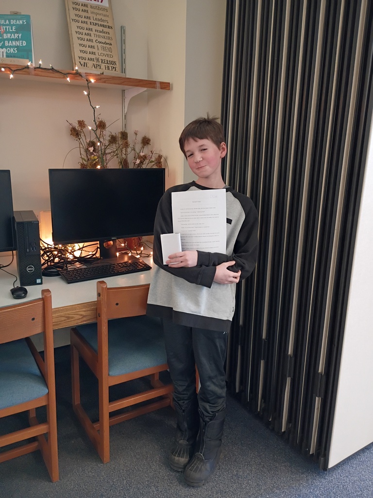 Cason in the library holding his story