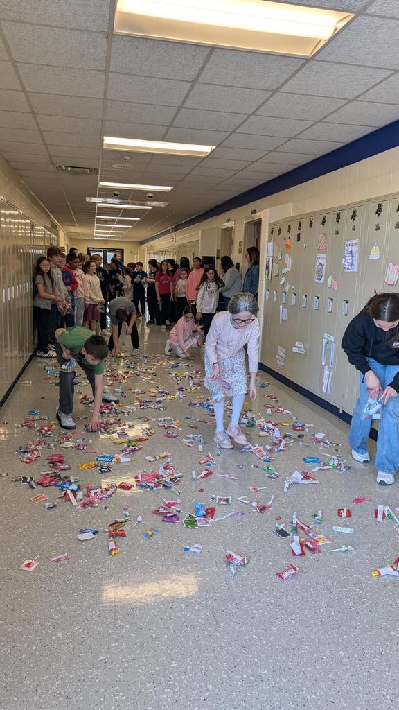 Students picking up candy off hall floor