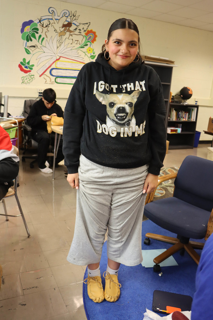 a student shows off her moccasins.