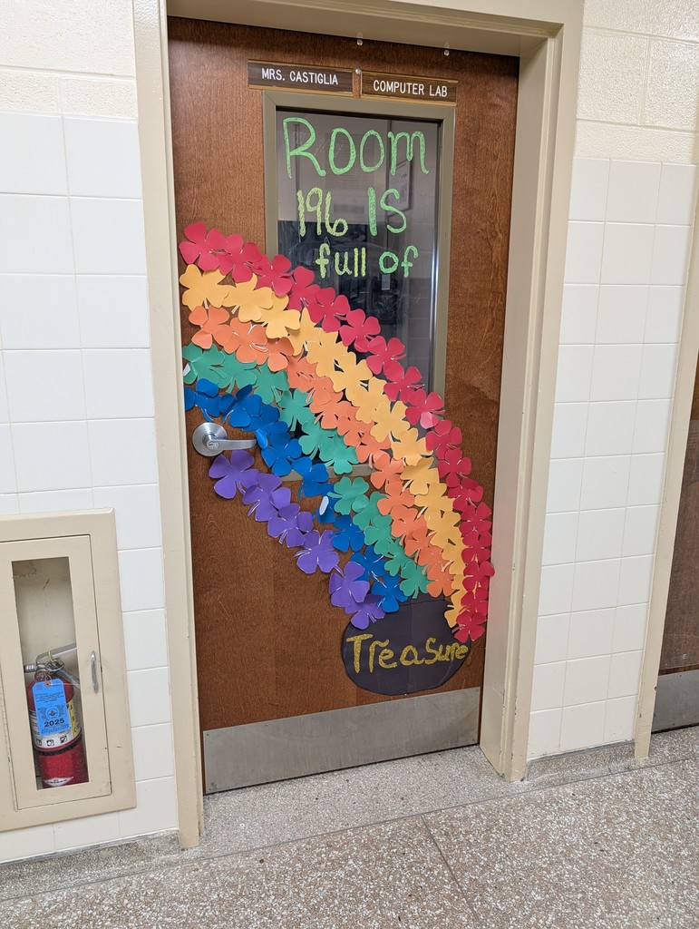 Door decorated with rainbow clover cutouts and pot of gold