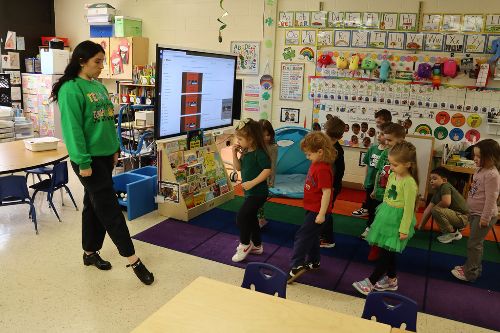 teacher shows students the steps