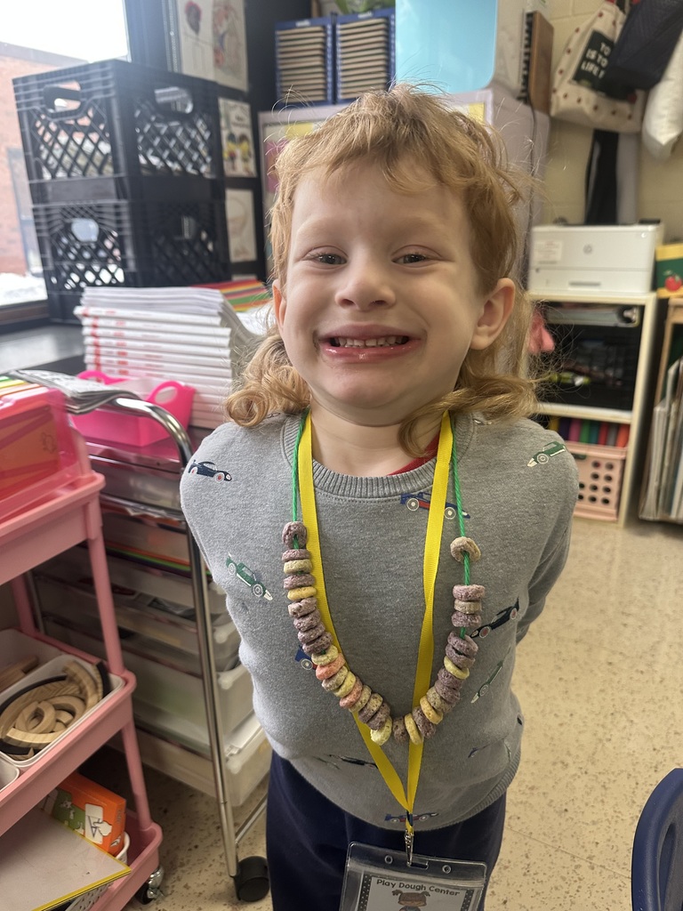 A boy wears his cereal necklace