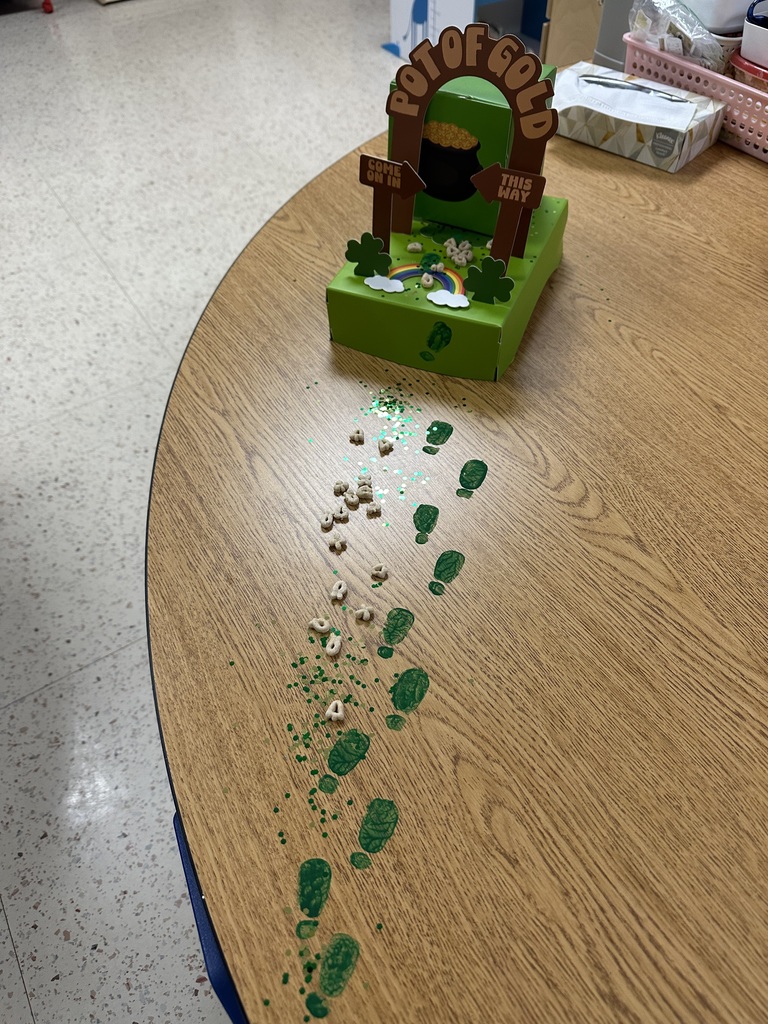 Green leprechaun footprints lead away from a trap