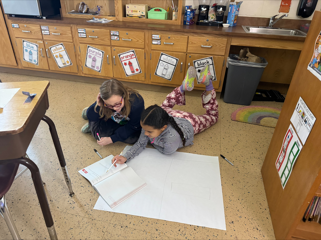 Students create a word problem on a big piece of paper