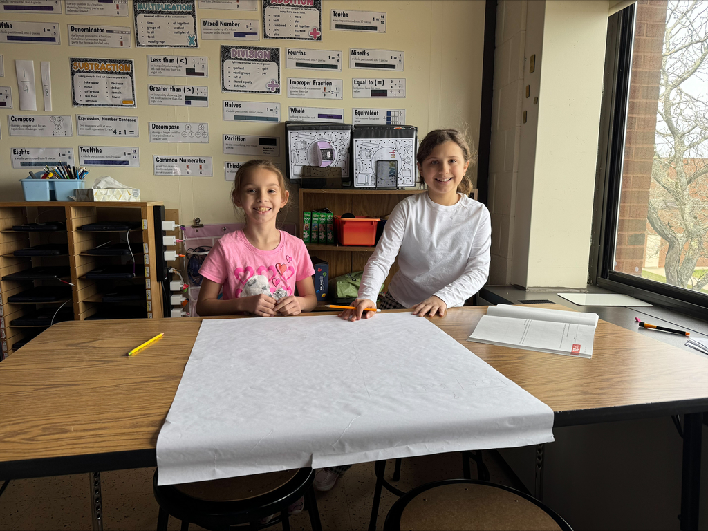 Students create a word problem on a big piece of paper