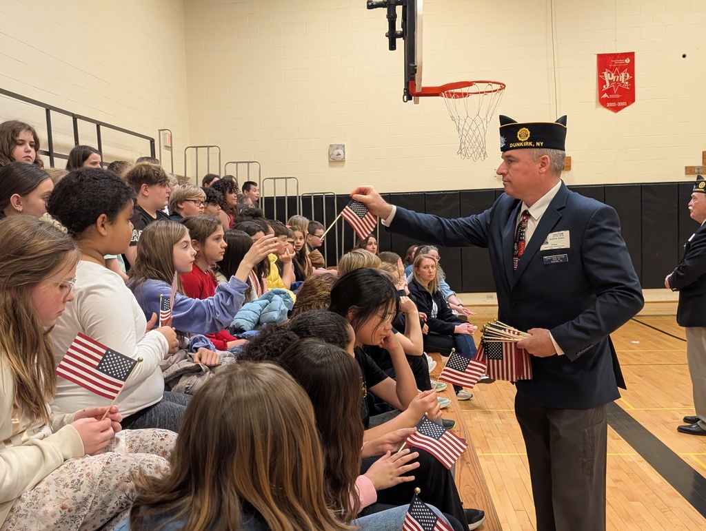 A veteran hands out flags. 