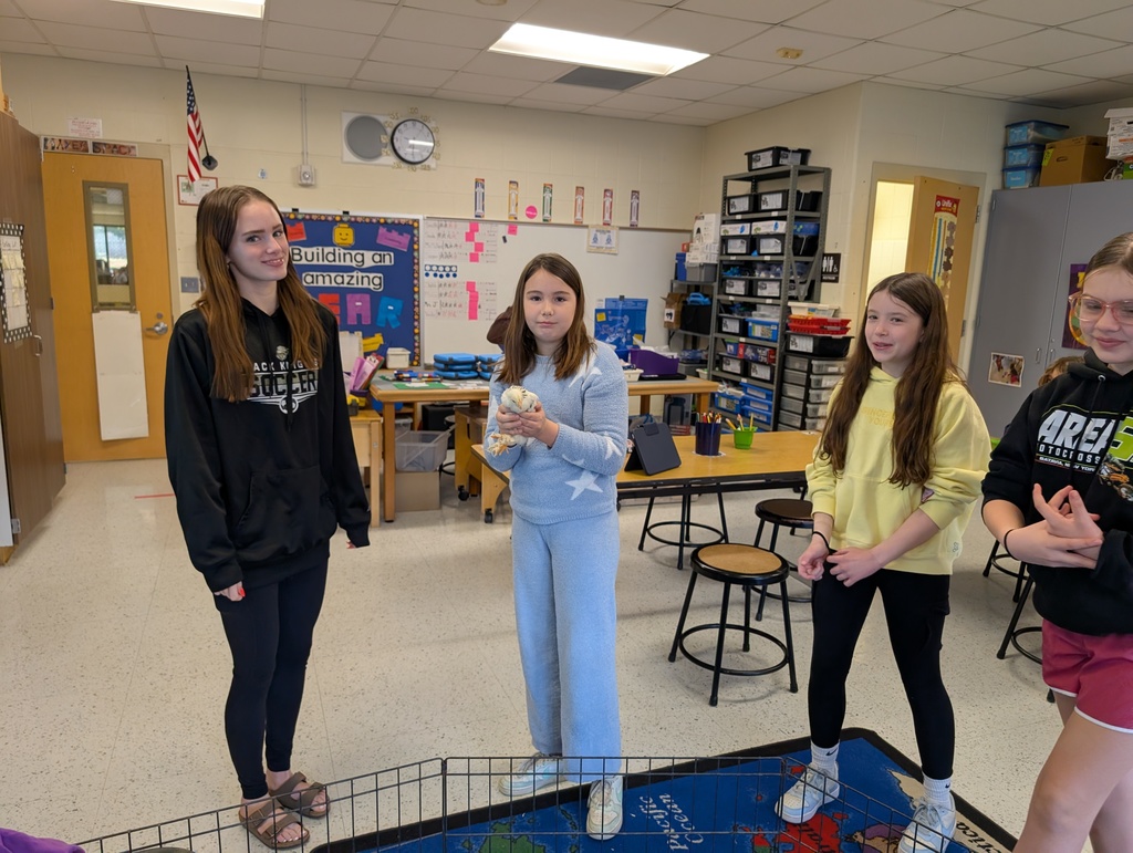 a girl holding the chick and Molly smiling