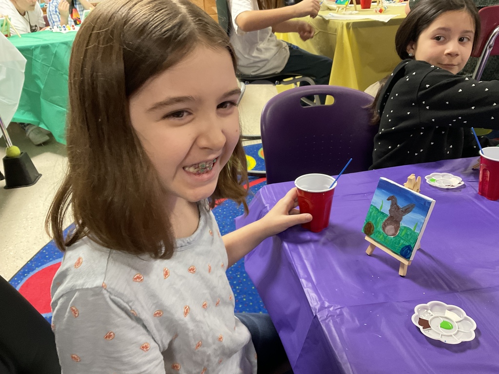 A student paints a canvas