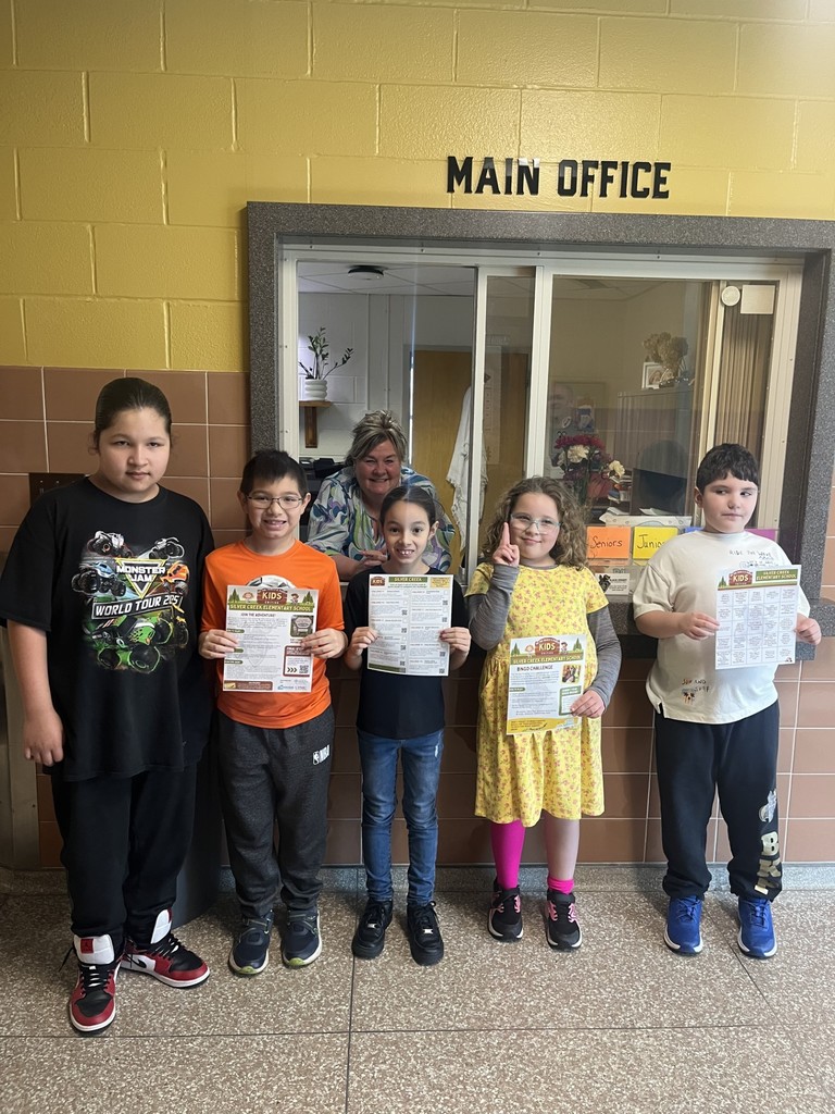 elementary students posing in front of the HS office