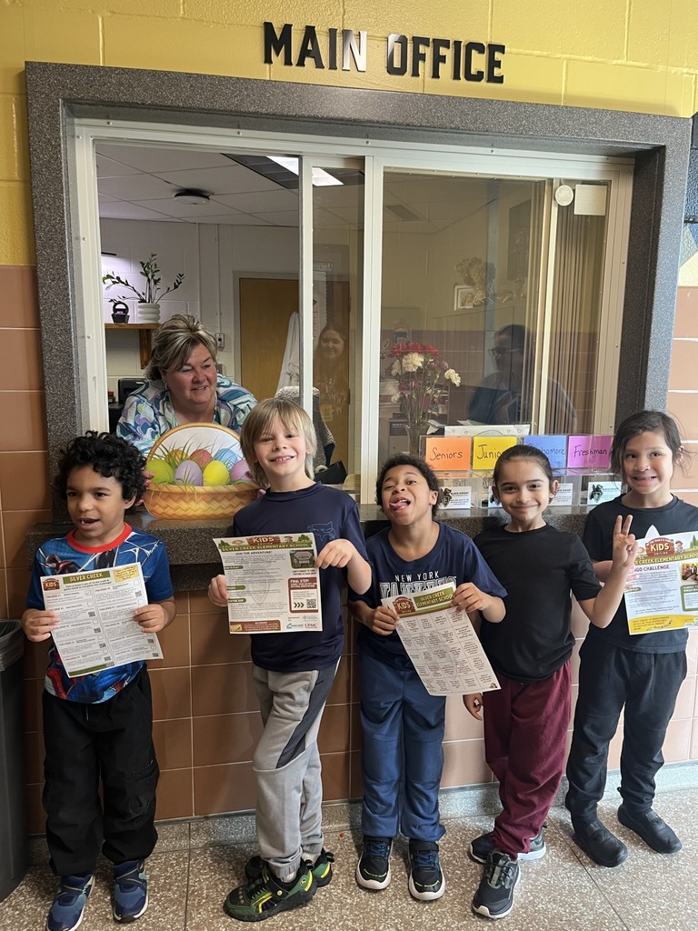 elementary students posing in front of the HS office