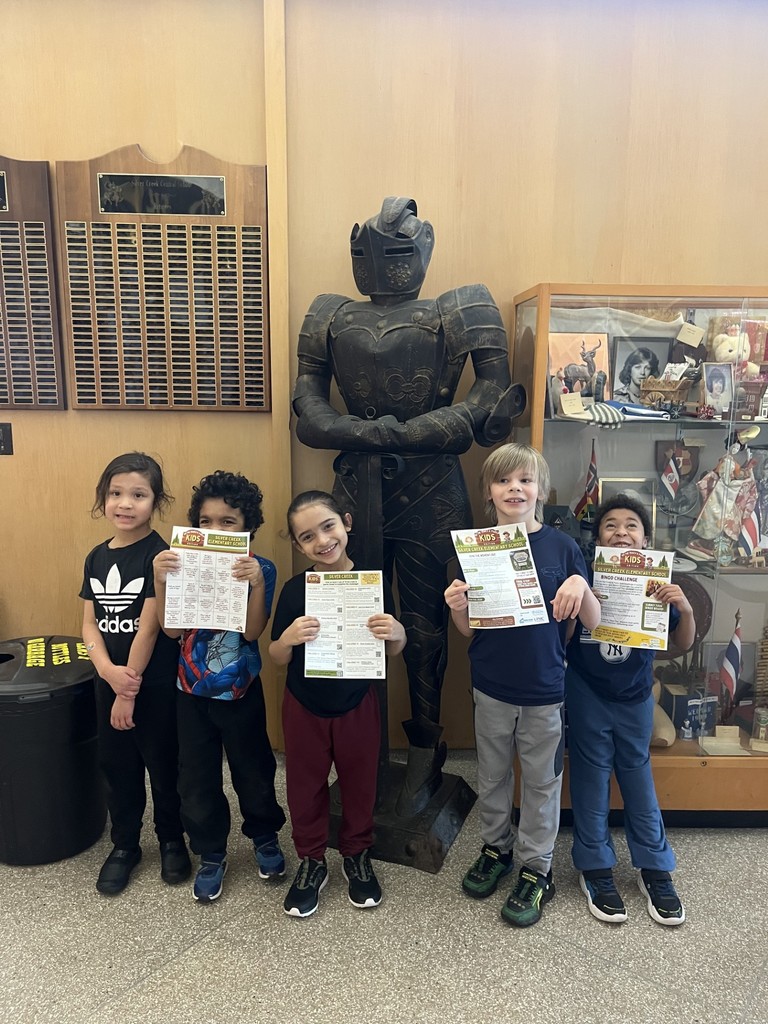 elementary students in the lobby by the knight statue