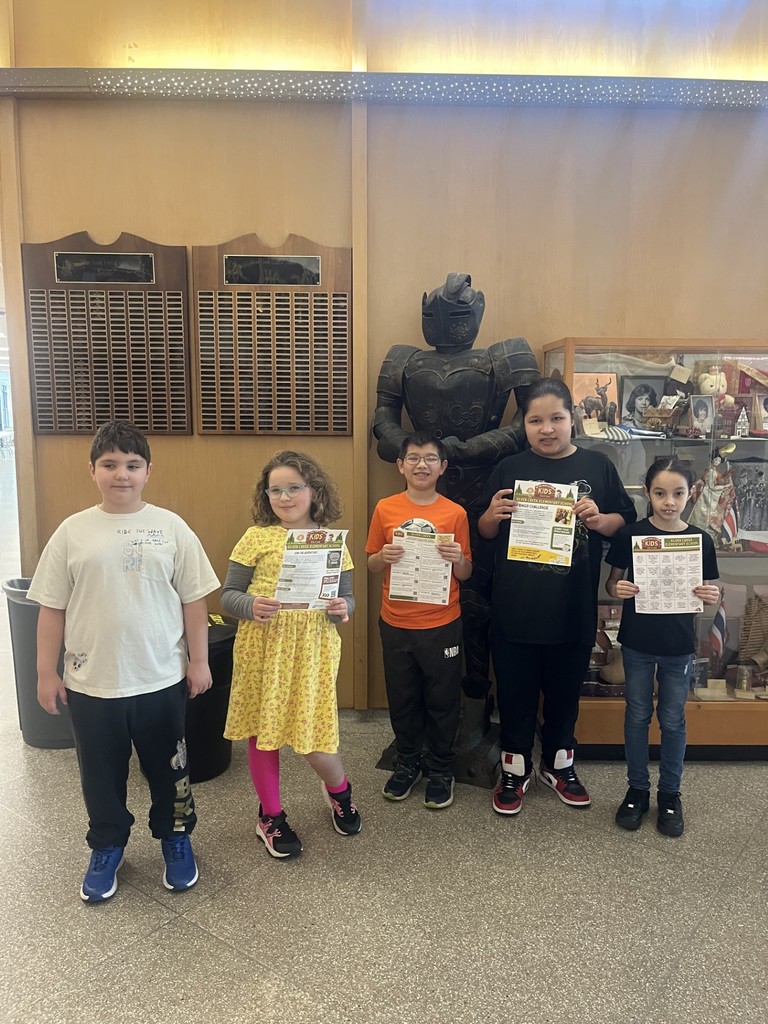 elementary students in the lobby by the knight statue