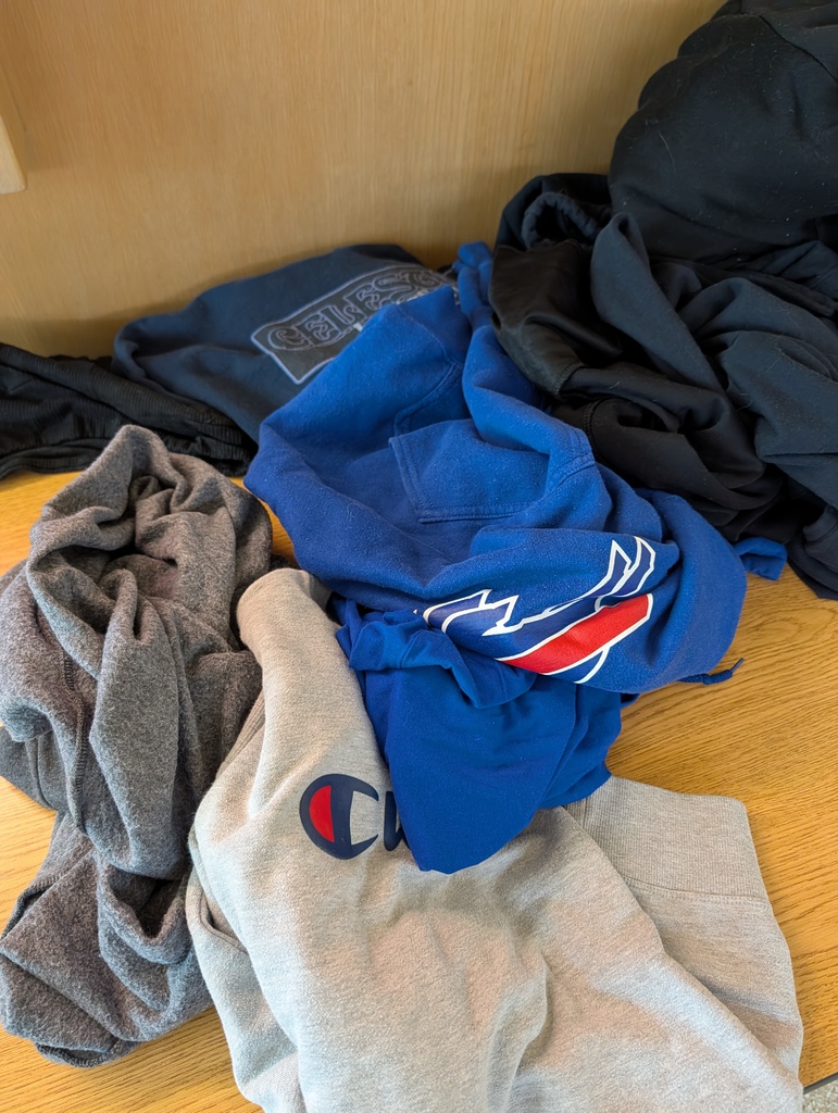 pile of hoodies on a table