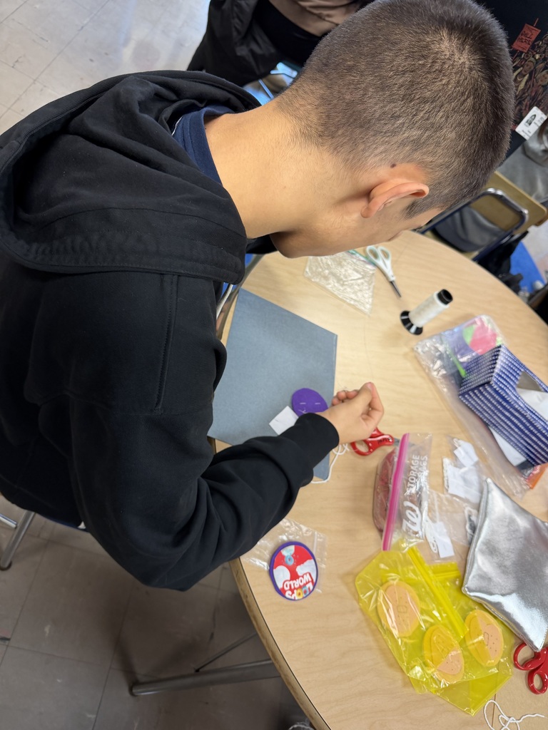 a student beads a pin