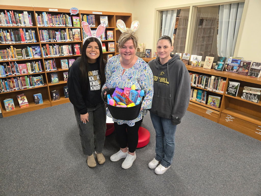Miss Potter, Mrs. Johnson & Mrs. Schneider in the lobby with an Easter basket