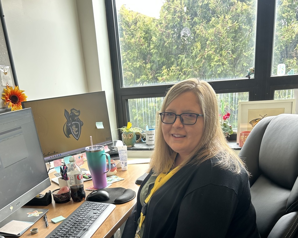 Laura smiling at her desk