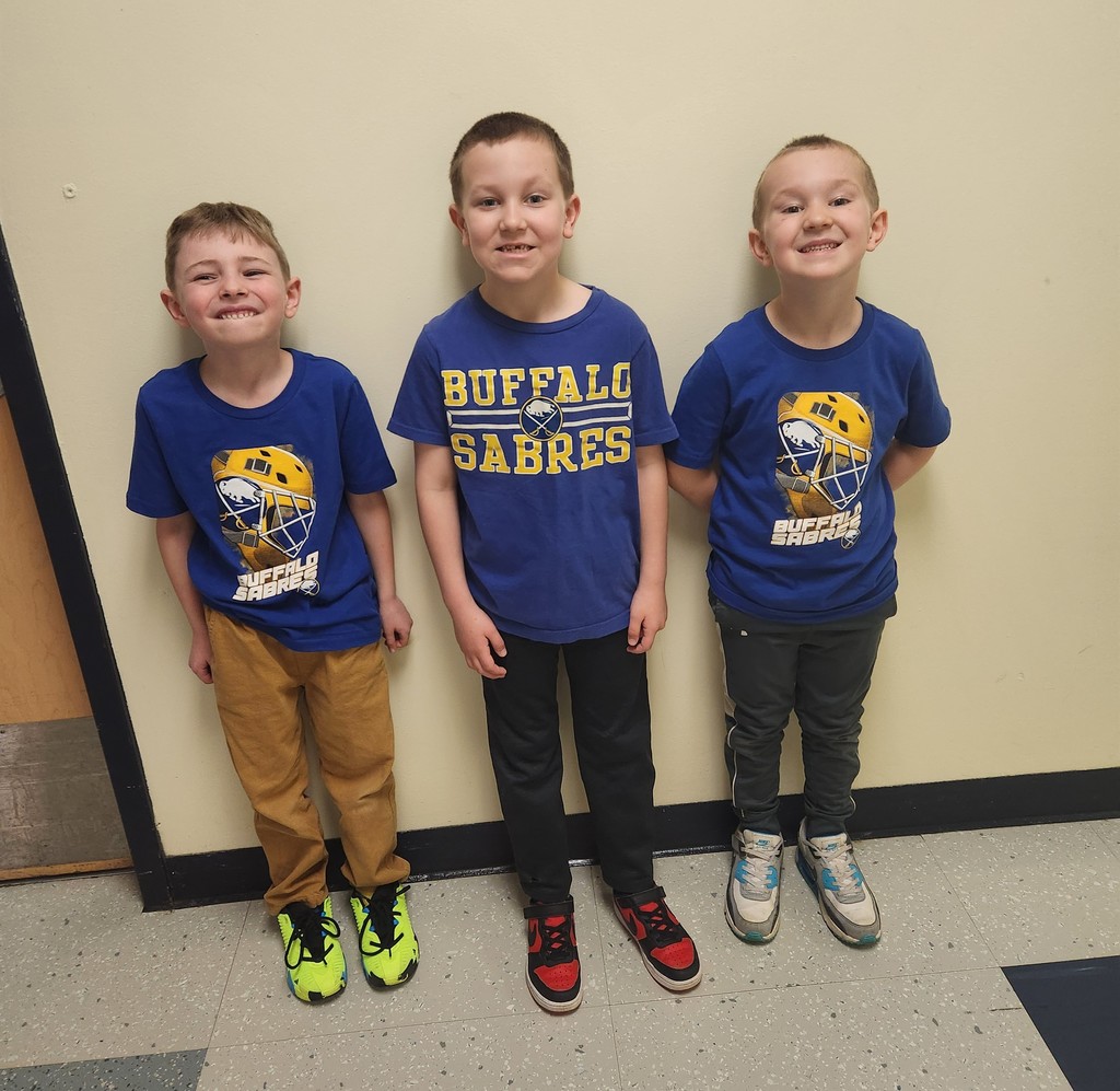 three elementary boys in blue Sabres t-shirts