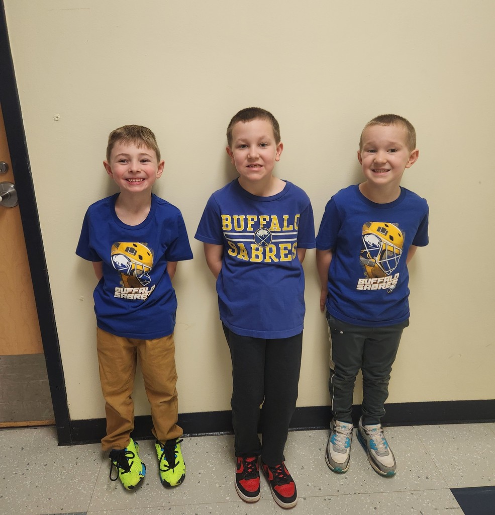three elementary boys in blue Sabres t-shirts
