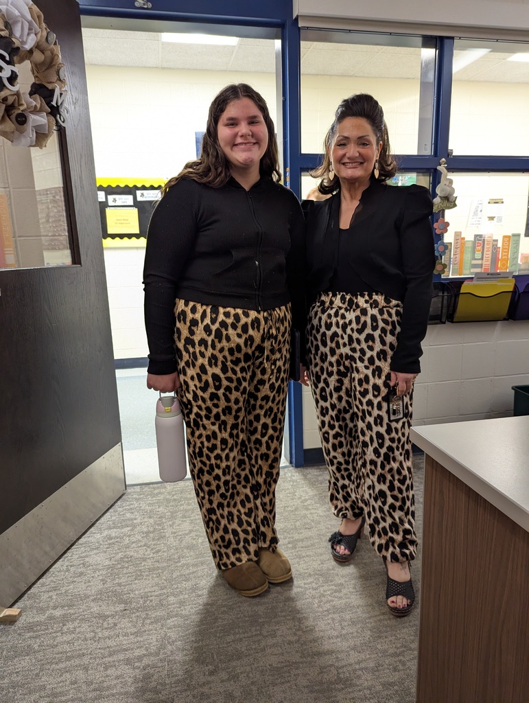 Twin in leopard and black outfits