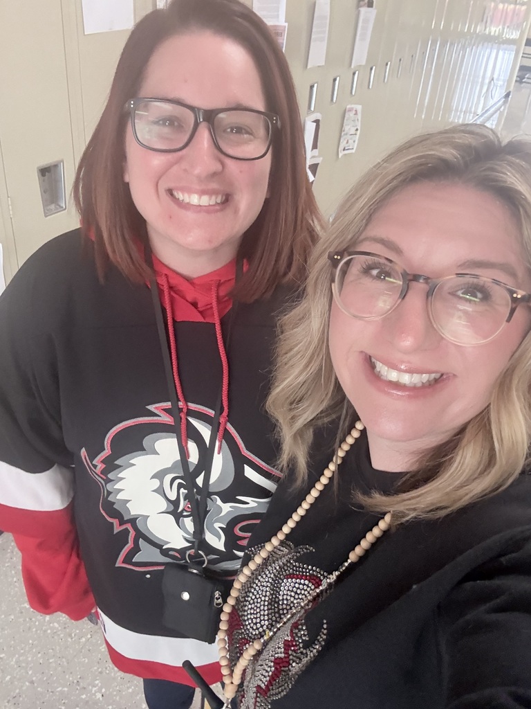 A teacher wears a Sabres' jersey with Mrs. Radoani. 
