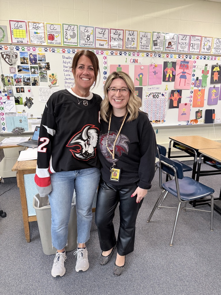 A teacher wears a Sabres' jersey with Mrs. Radoani. 