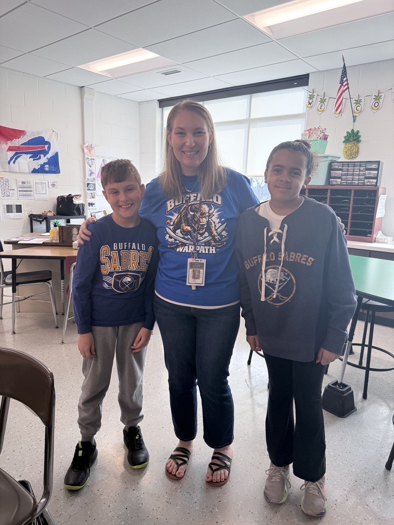 A teacher and two students wear Sabres shirts. 