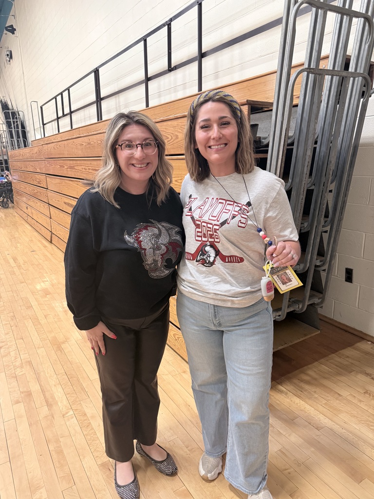 A teacher wears a Sabres shirt with Mrs. Radoani