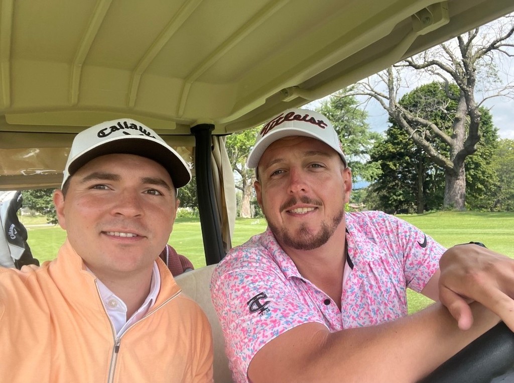 Jake and CJ in a golf cart