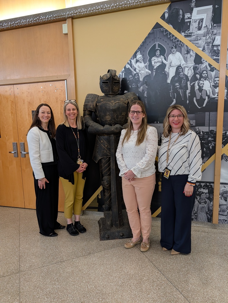 Dr. Ralston, Mrs. Helmer, Mrs. Casselberry and Mrs. Radoani smile in the lobby