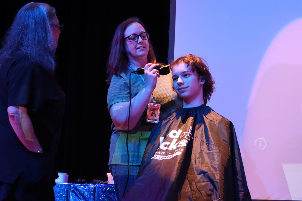 Mrs. Heller shaves Bryan's head. 