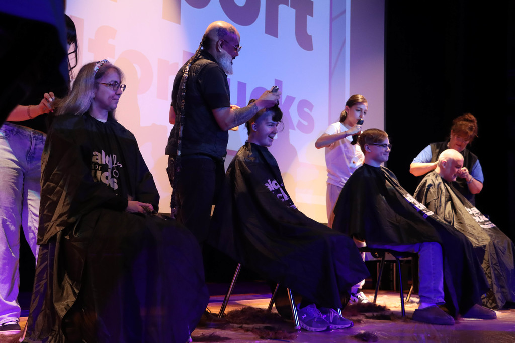 Students and staff go bald or cut their hair for donation.