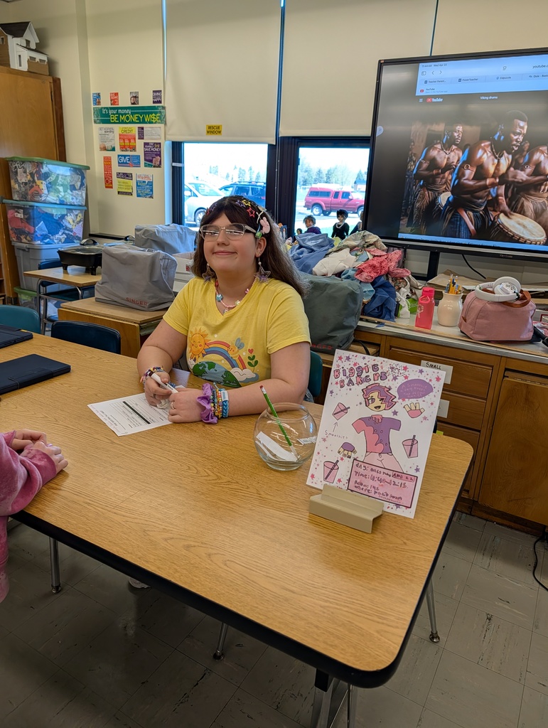 Student smiling at a table 