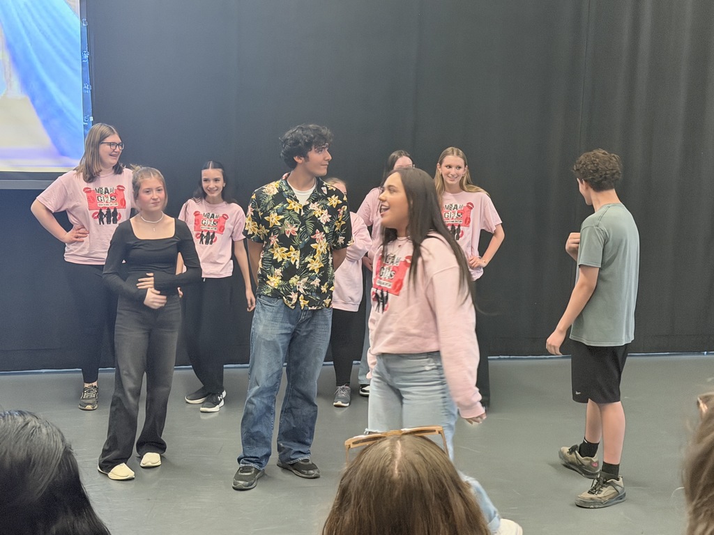 students performing dances on stage